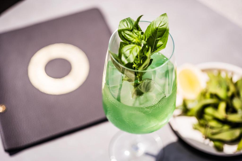 a glass vase with a plant in it on a table at MOOONS Vienna in Vienna