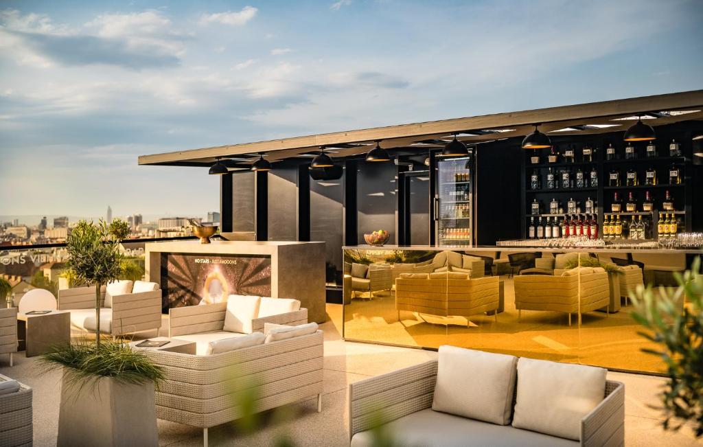 a rendering of a rooftop patio with couches and a fireplace at MOOONS Vienna in Vienna