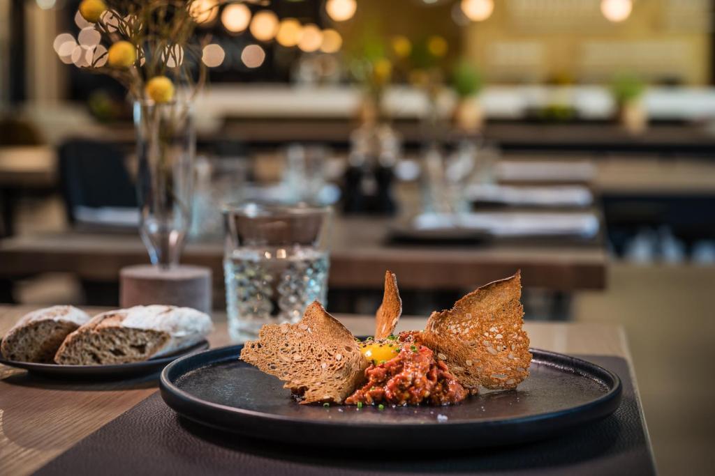 a plate of food on a table with bread at MOOONS Vienna in Vienna