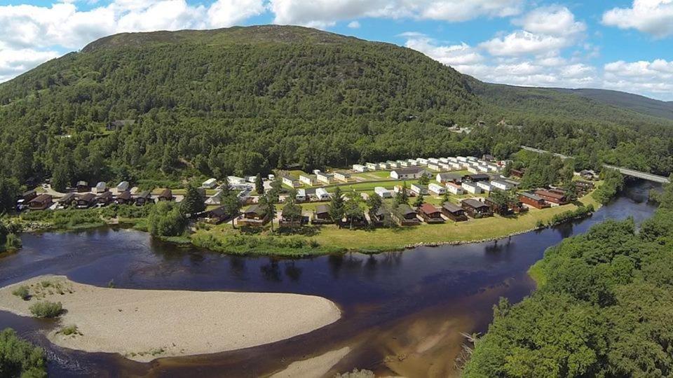 an aerial view of a resort on an island in a river at Feorag Lodge in Aviemore