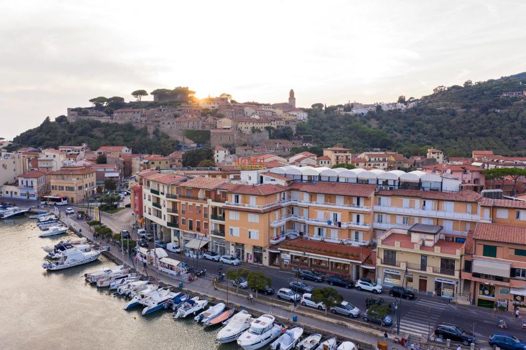 a view of a city with boats in a harbor at Hotel L'Approdo in Castiglione della Pescaia