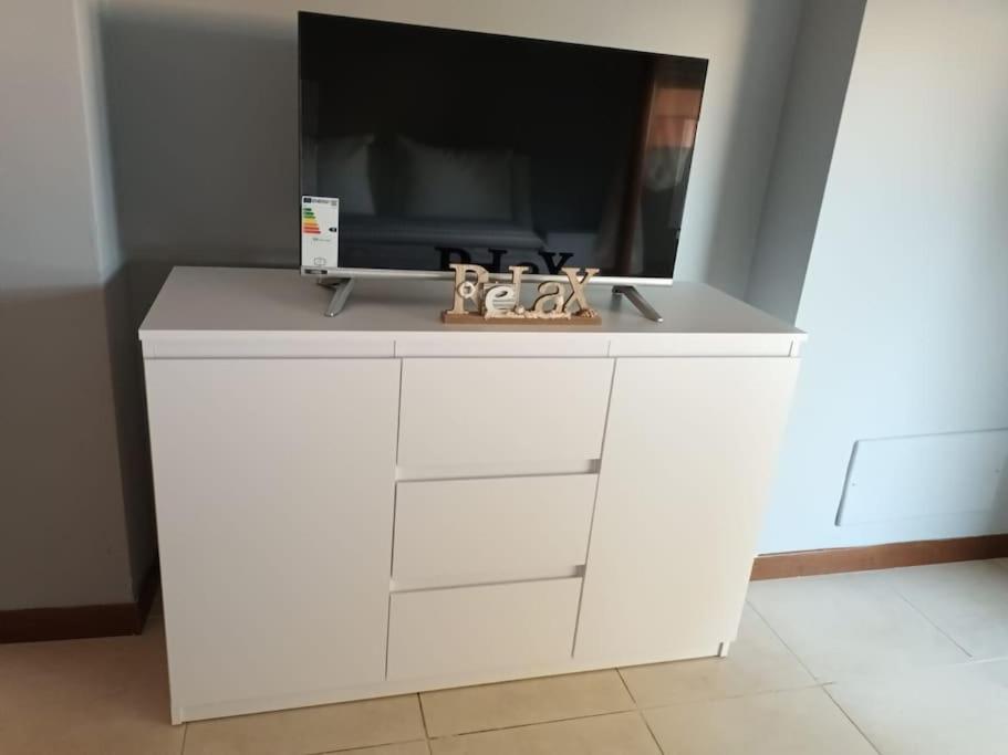 a white cabinet with a tv on top of it at La Sosta House Anzio in Anzio