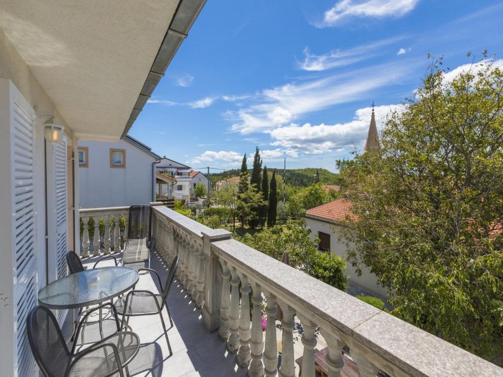 a balcony with a table and chairs and a view at Apartments Barbara 2 in Jadranovo