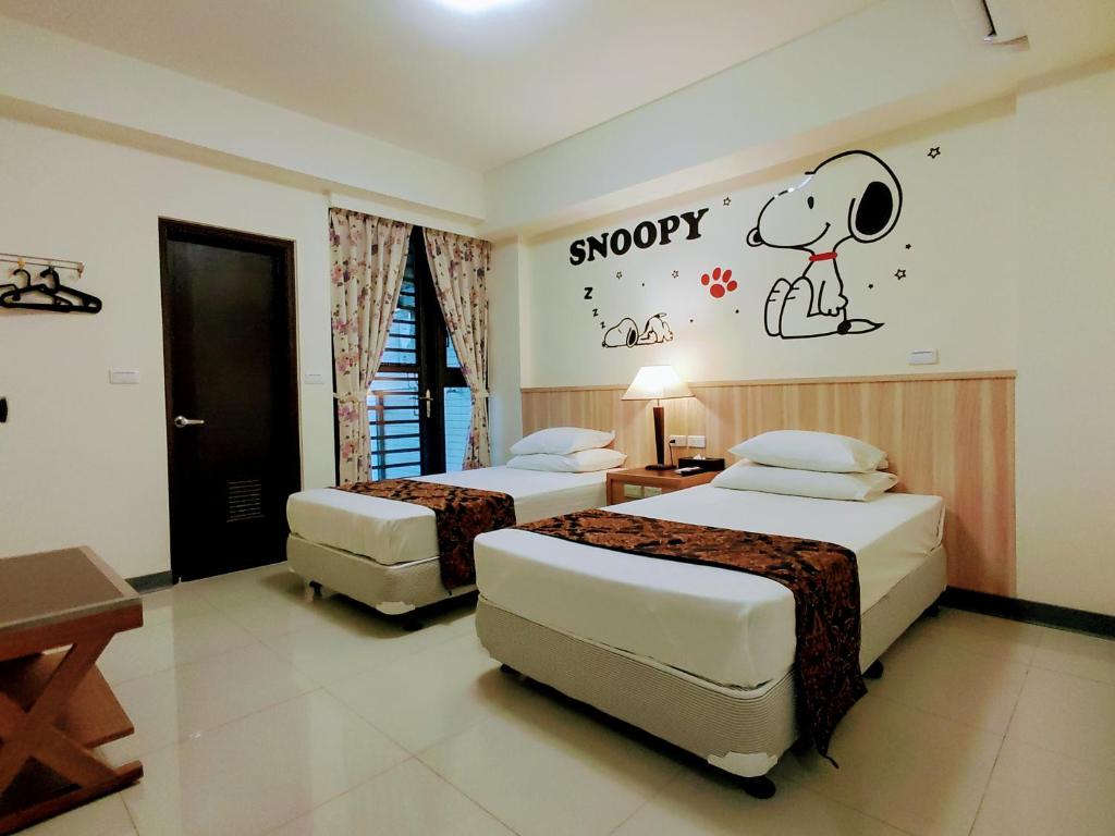 Postel nebo postele na pokoji v ubytování 礁溪幸福民宿Jiaoxi Happy Homestay