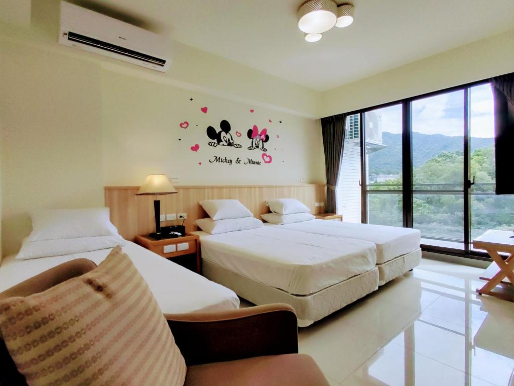 Postel nebo postele na pokoji v ubytování 礁溪幸福民宿Jiaoxi Happy Homestay