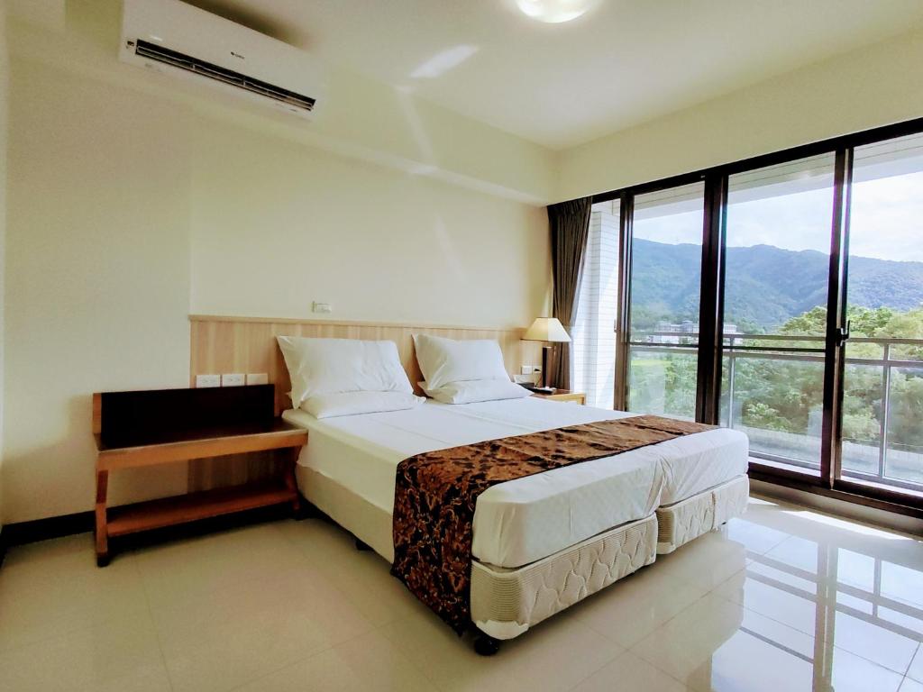 Postel nebo postele na pokoji v ubytování 礁溪幸福民宿Jiaoxi Happy Homestay