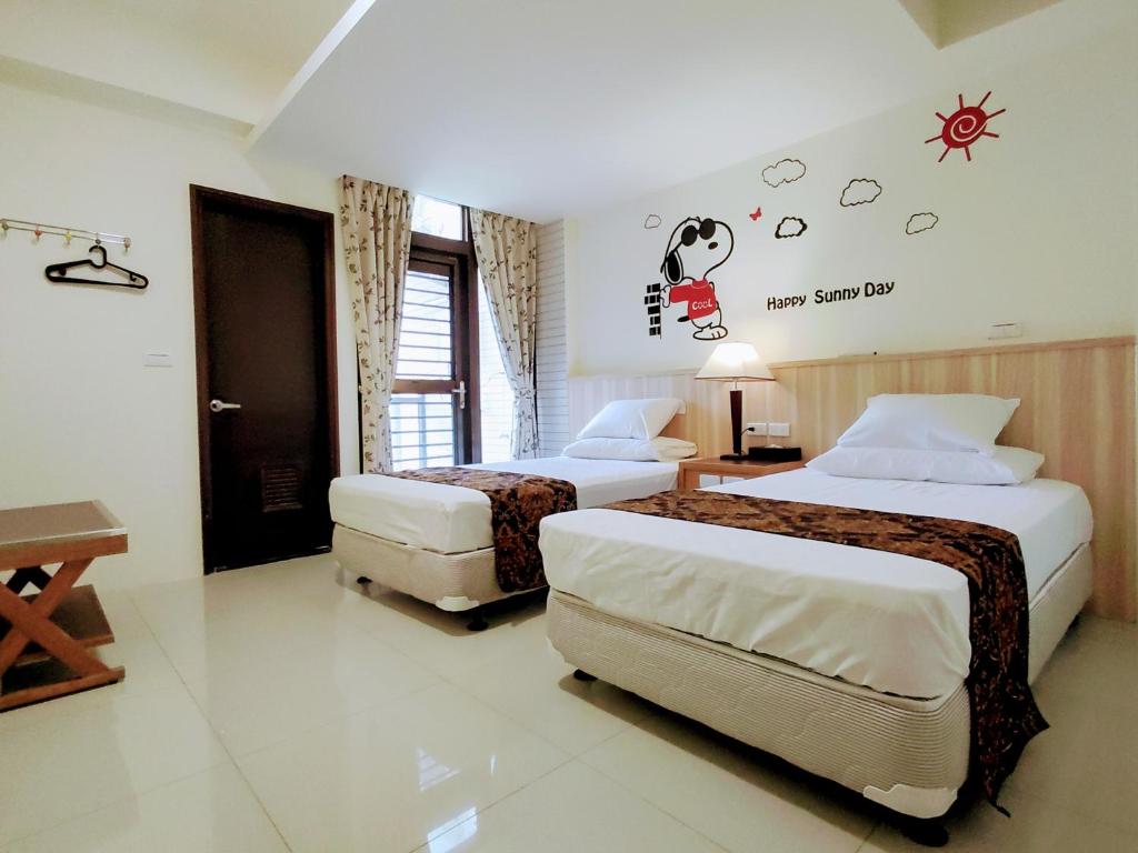 Postel nebo postele na pokoji v ubytování 礁溪幸福民宿Jiaoxi Happy Homestay
