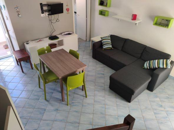 a living room with a couch and a table at VisitPonza - La tana di Bacco in Ponza