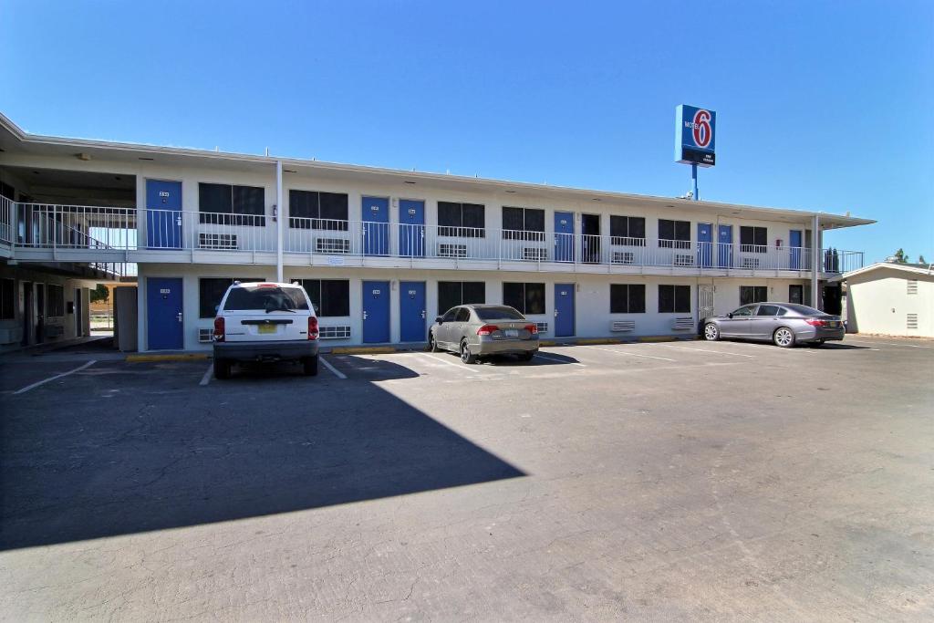 a large building with cars parked in a parking lot at Motel 6-Carlsbad, NM in Carlsbad