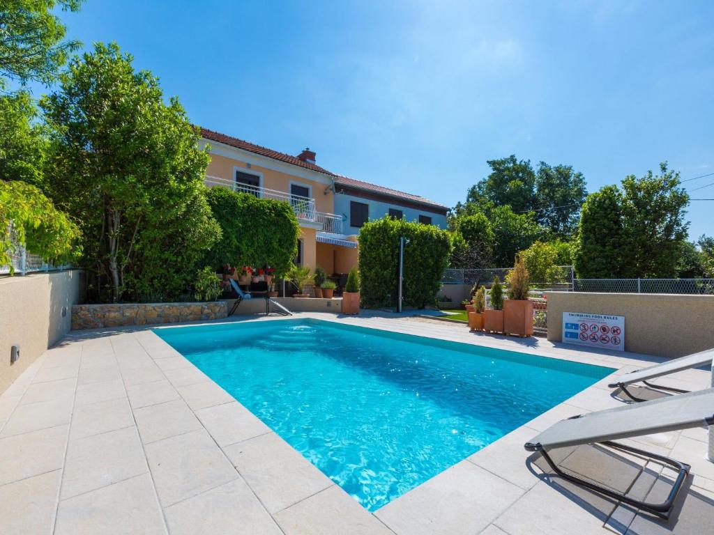 a swimming pool in the backyard of a house at Villa Lara in Jadranovo