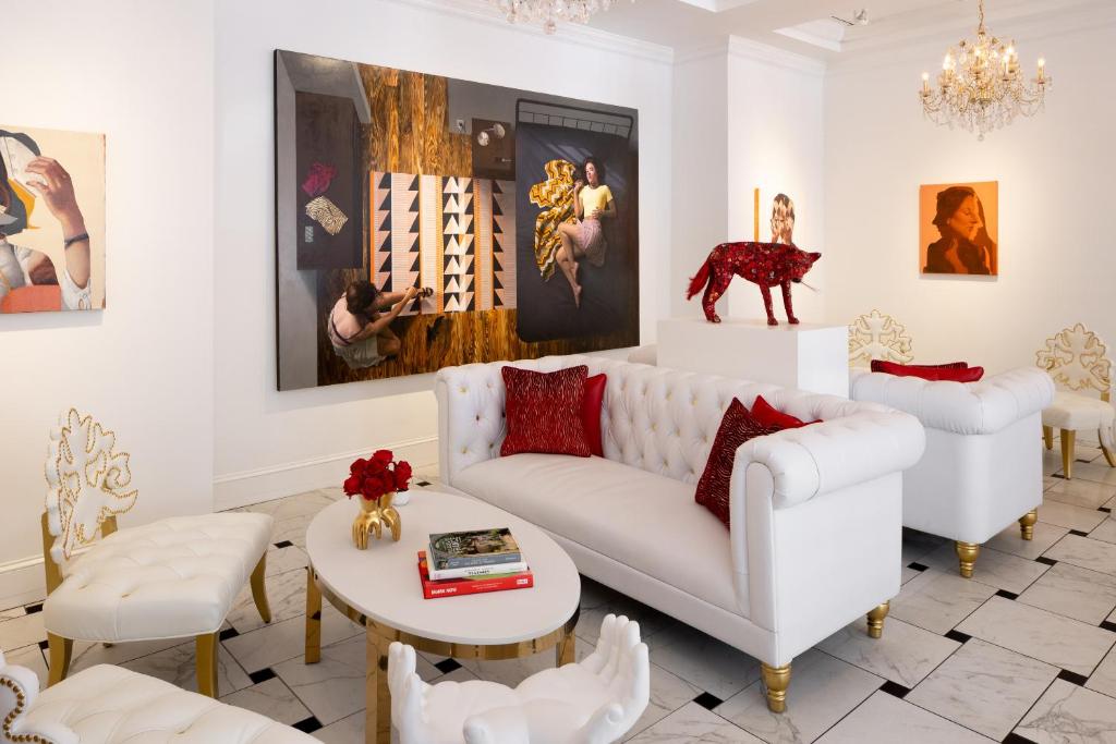 a living room with a white couch and a table at The Vendue, Downtown Art Hotel in Charleston