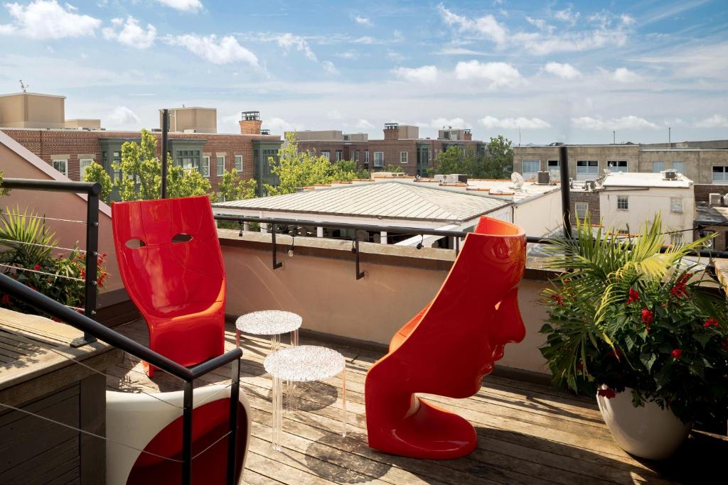 a balcony with red boots on a roof at The Vendue, Downtown Art Hotel in Charleston