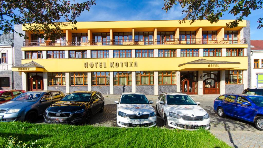 a hotel with cars parked in front of it at Hotel Kotyza in Humpolec