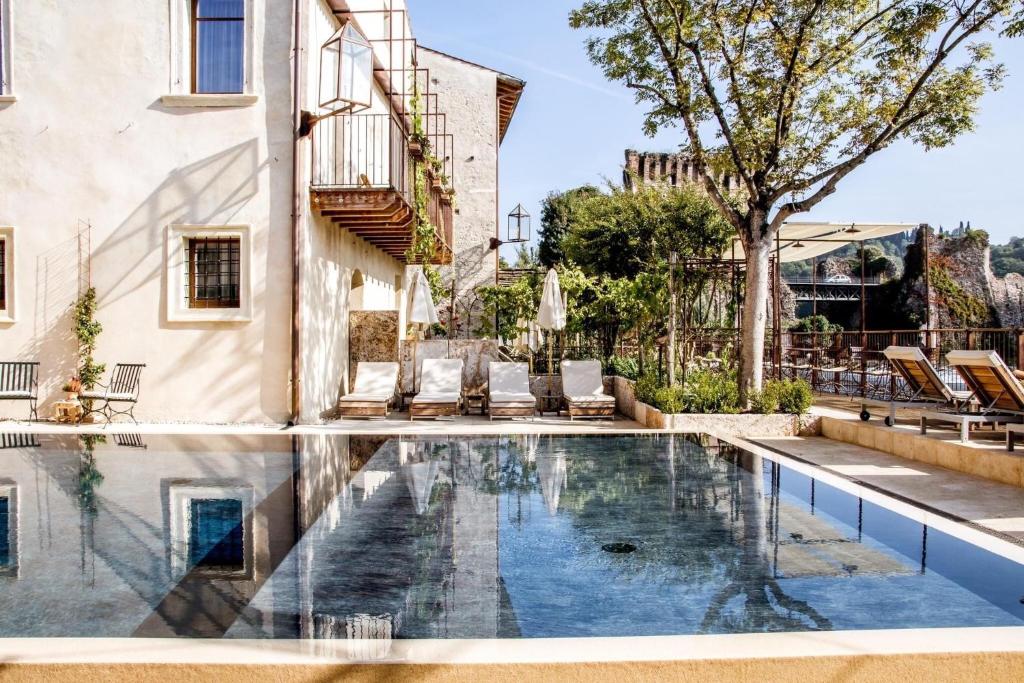 an image of a swimming pool in a house at Corte Regia Relais & Spa in Valeggio sul Mincio