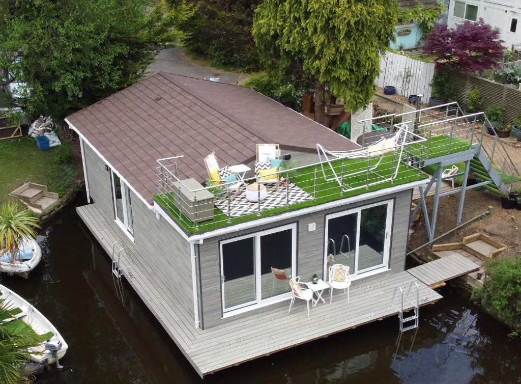 an aerial view of a tiny house on the water at Tulana Taggs - floating home on island idyll in Hampton Hill