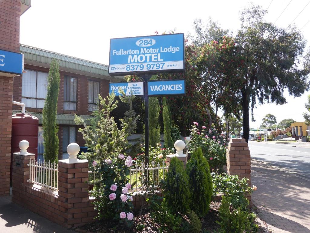 un cartello per un motel di fronte a un edificio di Fullarton Motor Lodge a Adelaide