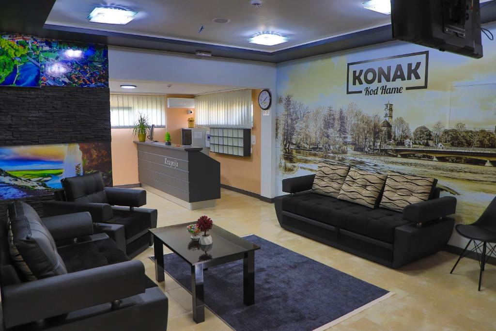 a living room with couches and a tv in it at Konak kod Hame in Bihać