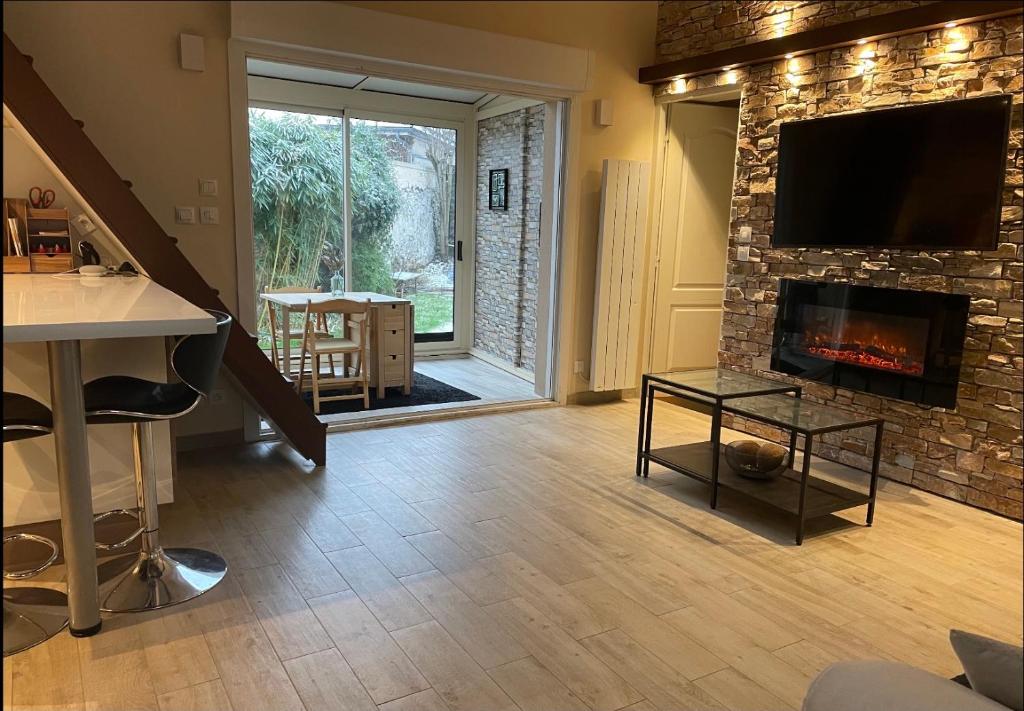 a living room with a fireplace and a tv at Olympic Games 20 min from Paris and CDG Aeroport Luxurious House with garden and parking in Eaubonne