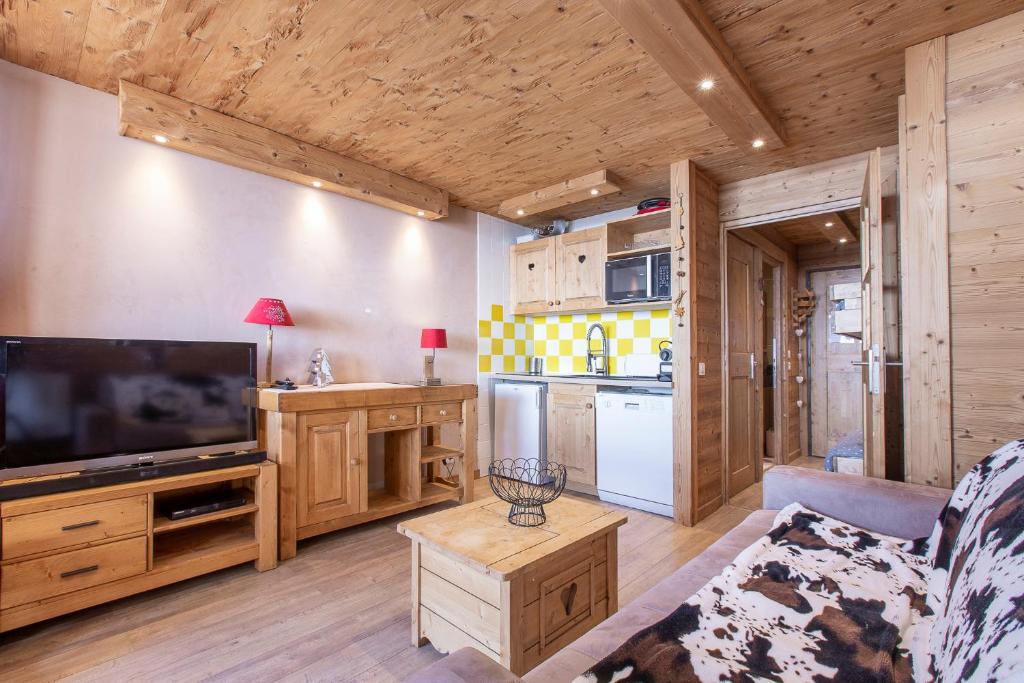 a living room with a large flat screen tv at Résidence Le Sérac - Val Thorens in Val Thorens