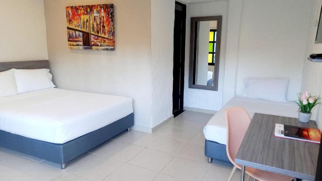 Postel nebo postele na pokoji v ubytování Hotel Vanguardia Natural