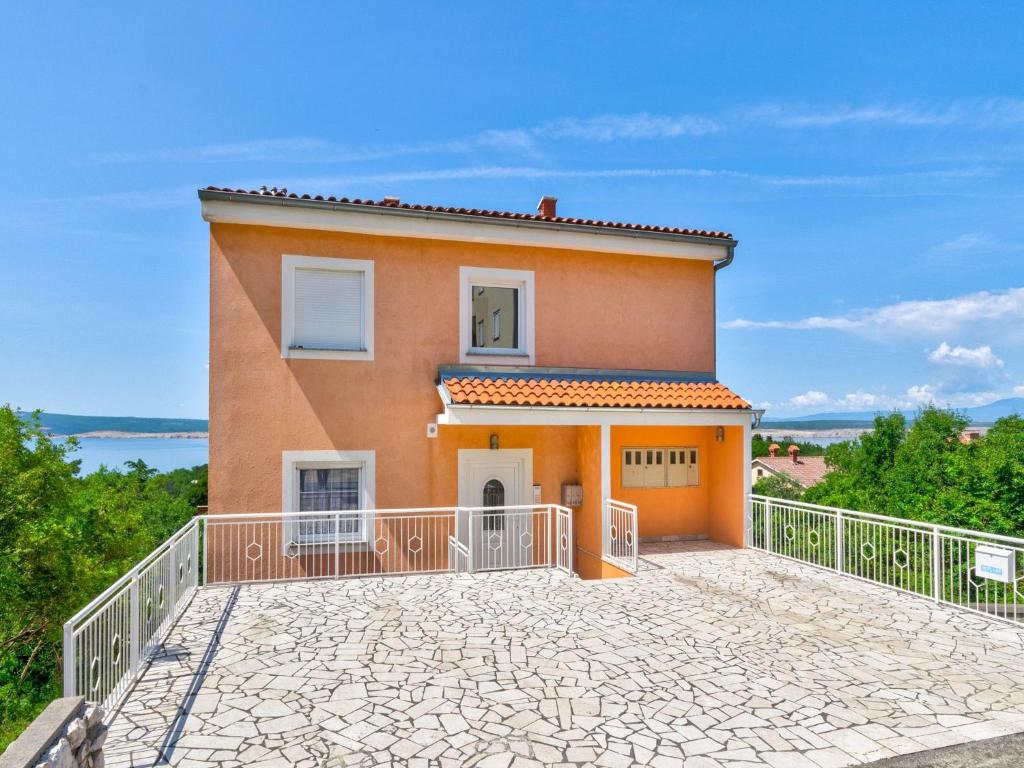 a large orange house with a large balcony at Apartment Nenad in Dramalj