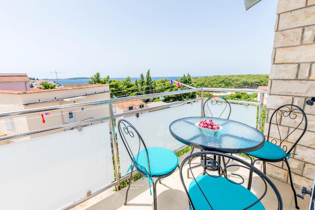 a balcony with a table and chairs on it at Apartment Dora in Primošten