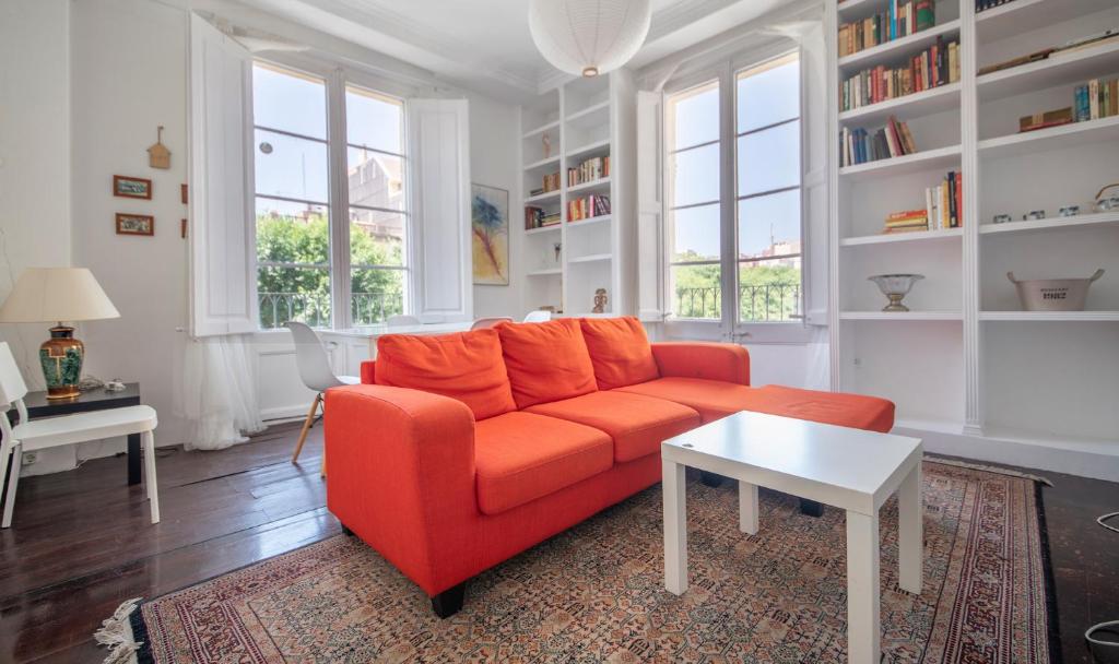 a living room with an orange couch and a table at TarracoHomes, TH160 Apartamento Rius in Tarragona