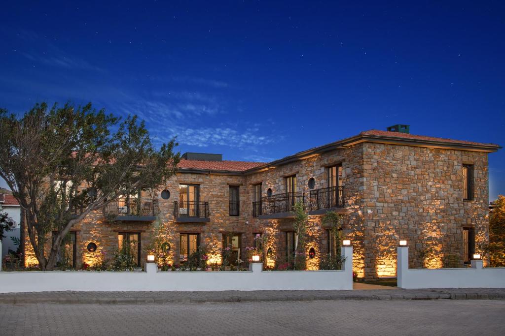 a large brick building with lights on it at night at MELİTYA Hotels in Kalekoy