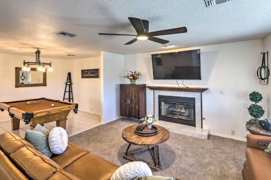 a living room with a couch and a pool table at Luxe Home with Detached Casita and Furnished Patio! in Bullhead City