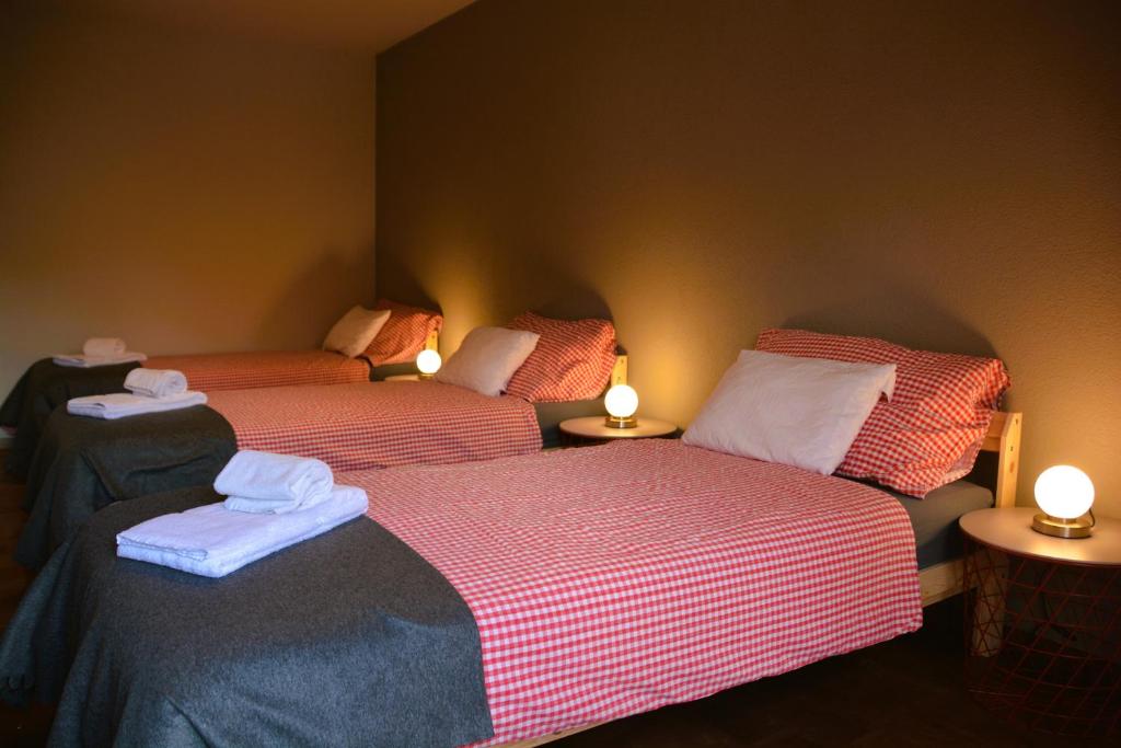 a room with two beds and two tables with lights at Mayers Swiss House, private home for 2-6 guests in Matten