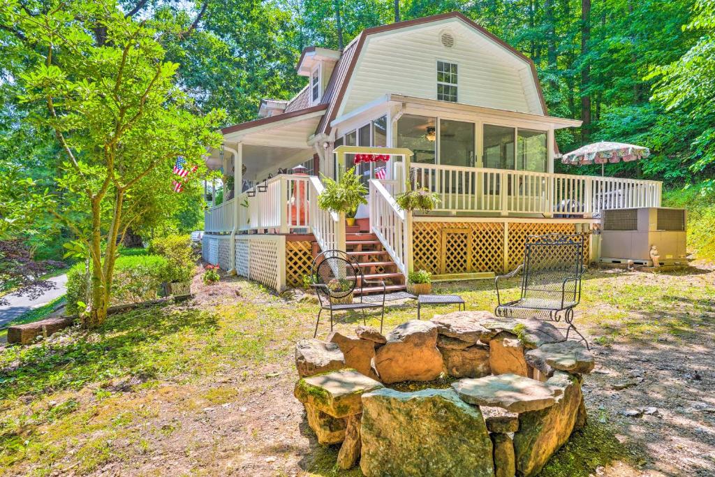 a house with two chairs and a tree stump at Secluded Chattanooga Getaway with Deck and Yard! in Chattanooga