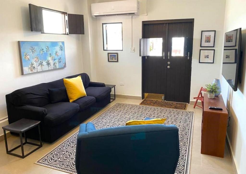 a living room with a blue couch and a door at KASA Charming Luna 2 bedroom in San Juan