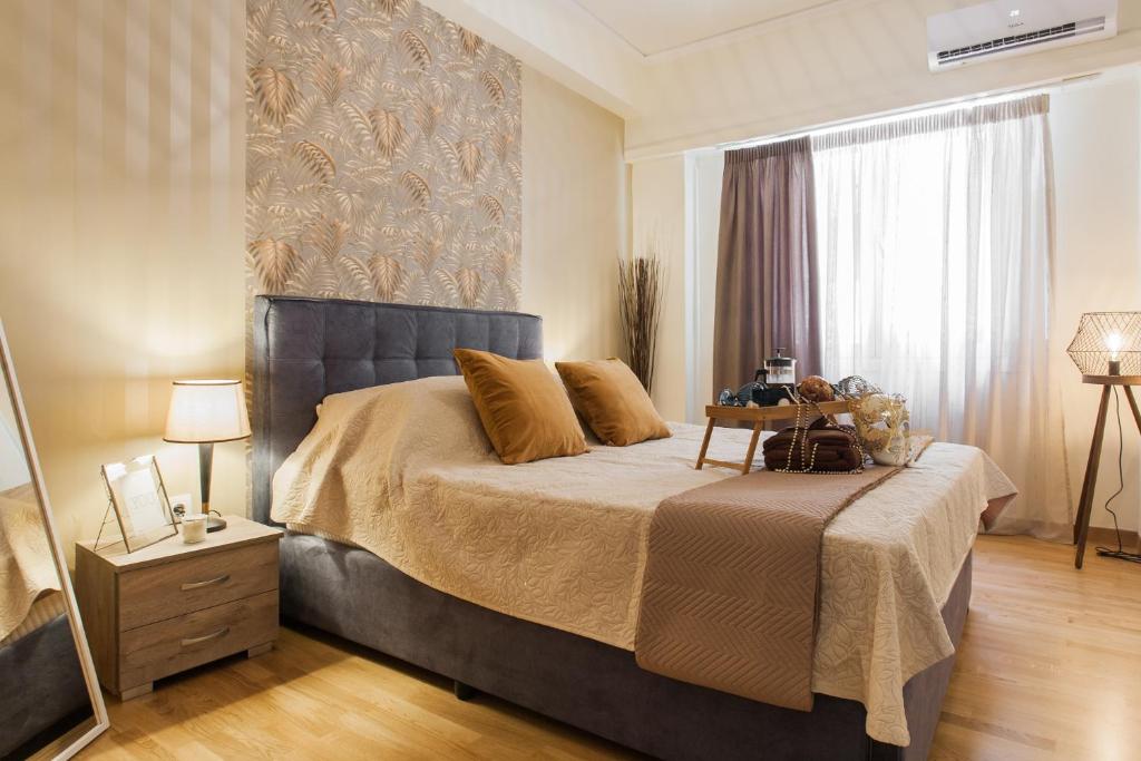 a bedroom with a large bed and a window at Lovely renovated apartment walk to Acropolis in Athens