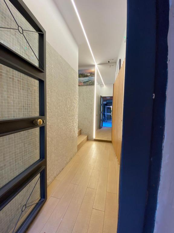 a hallway with a door and a tile wall at Continental Space in Málaga