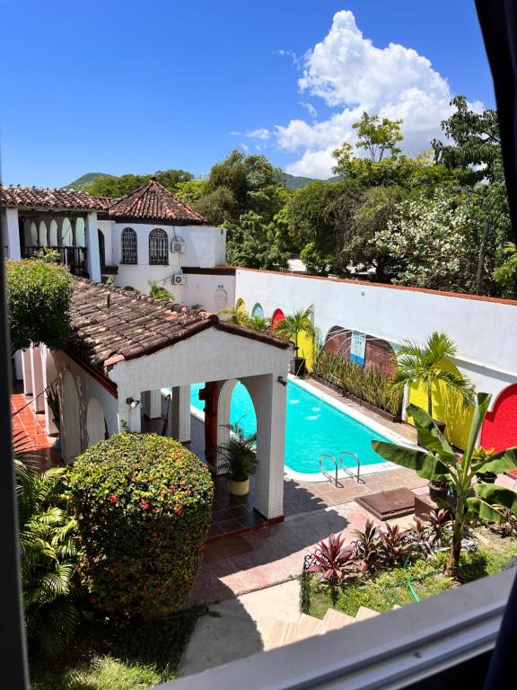 a view of a house with a swimming pool at The Chill in Mansion Hostel Santa Marta in Santa Marta