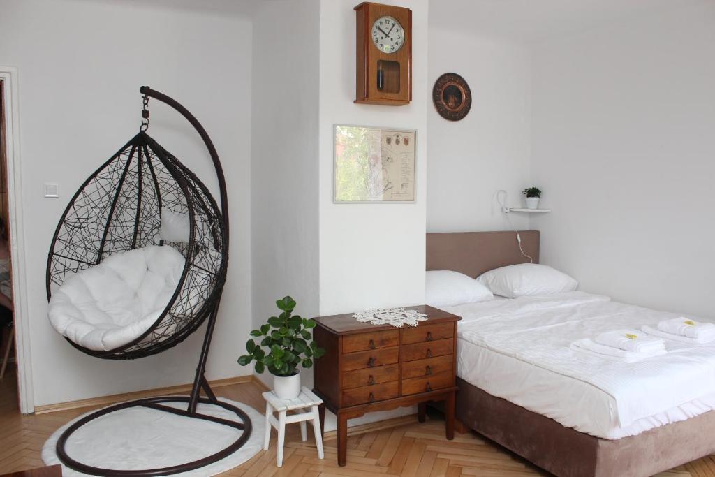 a bedroom with a bed and a hanging swing at Galicja Apartamenty in Rzeszów