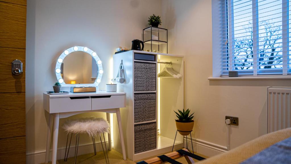 a dressing table and a mirror in a room at The Duplex Margate with Deck & Living Space Air Conditioning in Margate