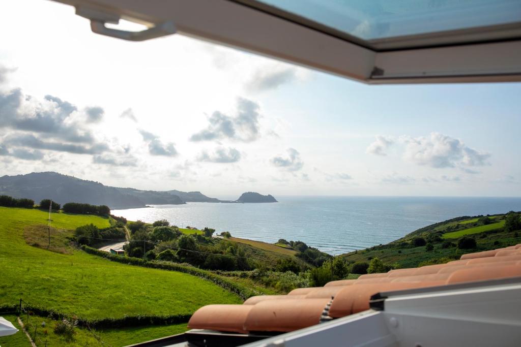 a view of the ocean from a house at Hotel Boutique Berazadi Berri in Zarautz