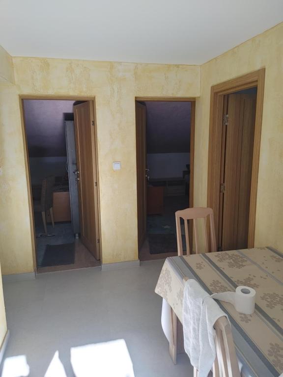 a room with a table and two sliding doors at Vila Sipovac in Budva