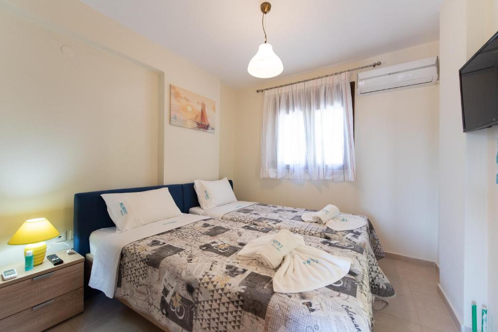 A bed or beds in a room at Ariadni -Villas- luxury houses