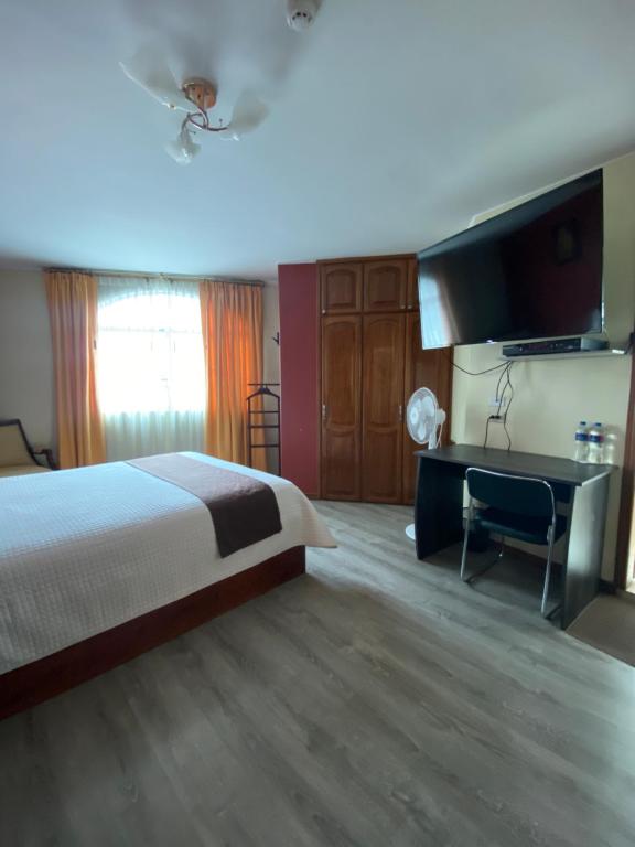 Postel nebo postele na pokoji v ubytování Hotel Cumbayá Sanvy