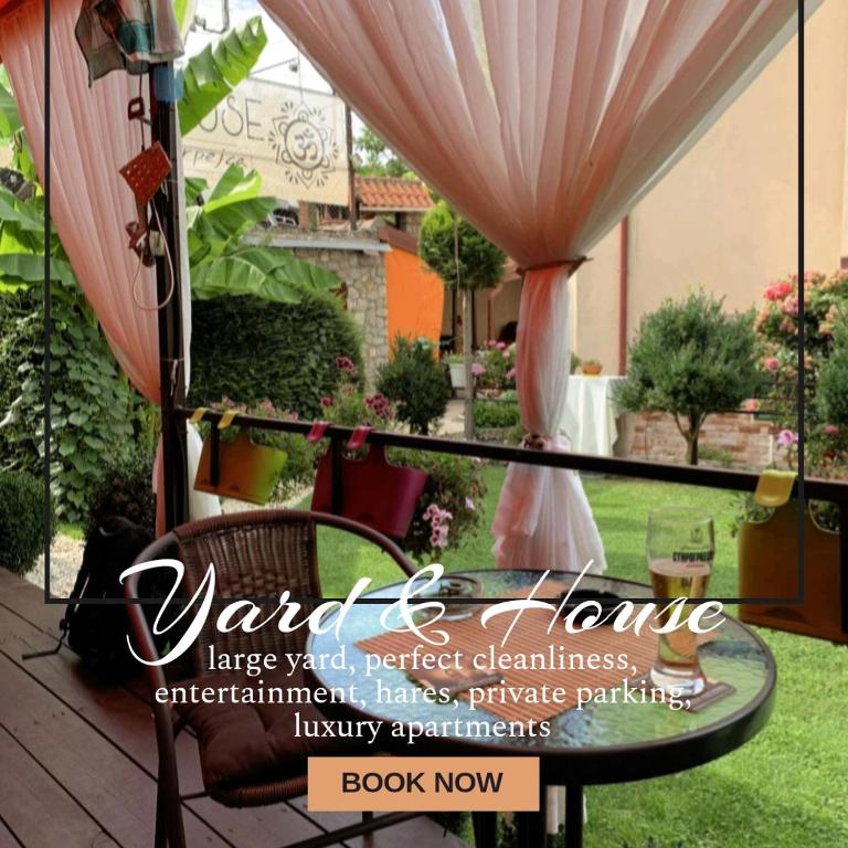 a view of a patio with a table and a garden at Yard House Trpejca in Ohrid
