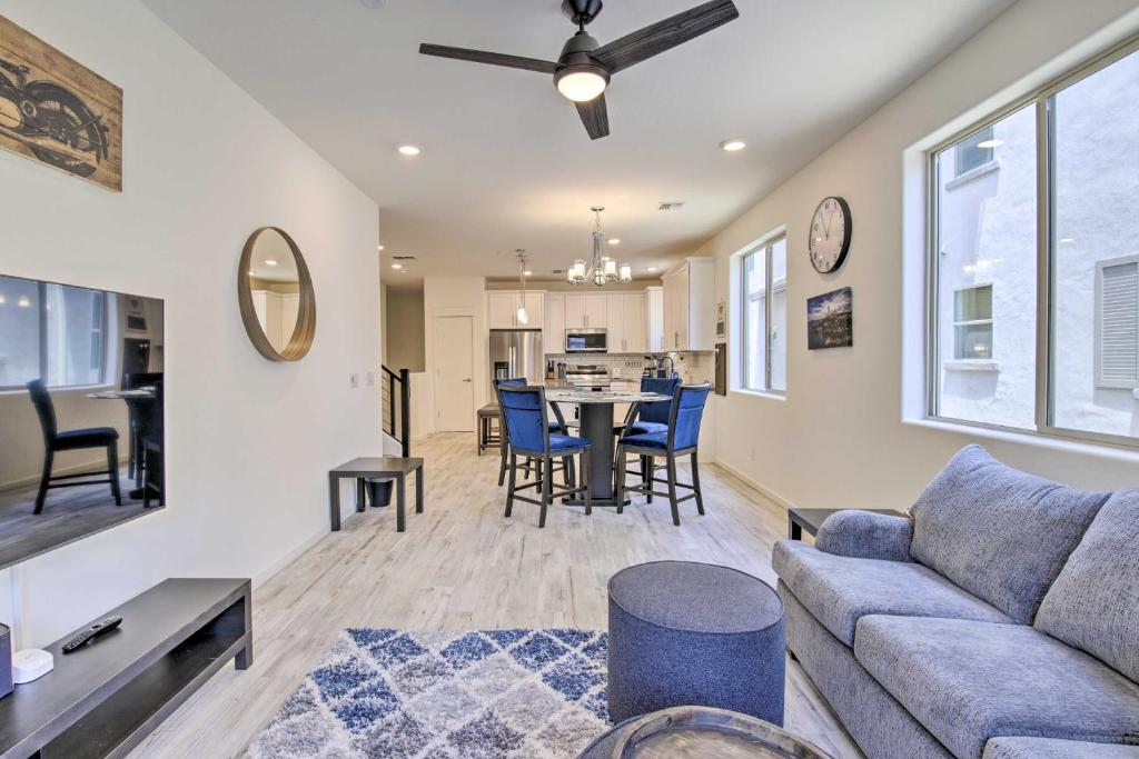 a living room with a couch and a table with chairs at Executive Chandler Townhome with Community Perks in Chandler