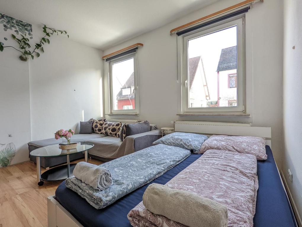 a living room with two beds and a couch at 6 people Vacation Apartment In The Black Forest in Villingen-Schwenningen