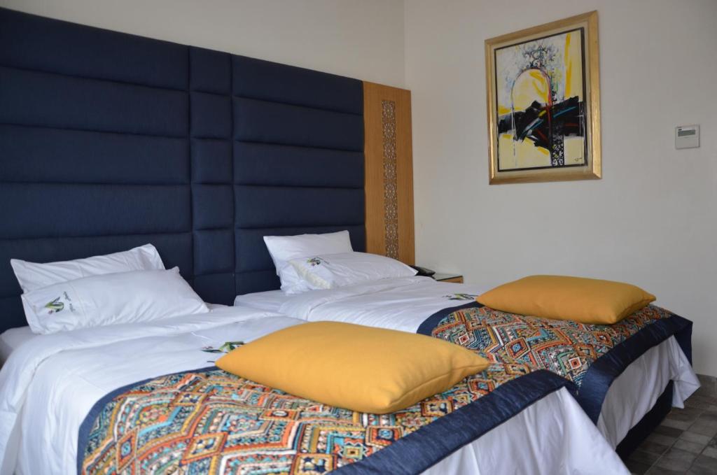 Postel nebo postele na pokoji v ubytování Aralia Boutique Hôtel