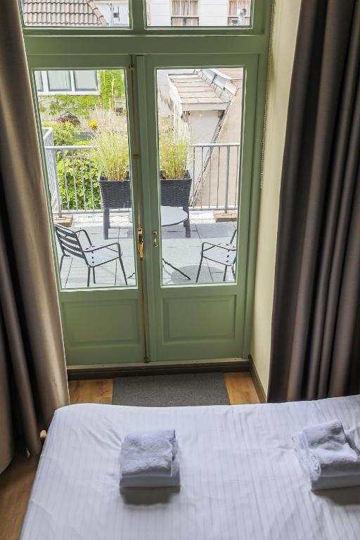 Postel nebo postele na pokoji v ubytování Hotel Corps de Garde