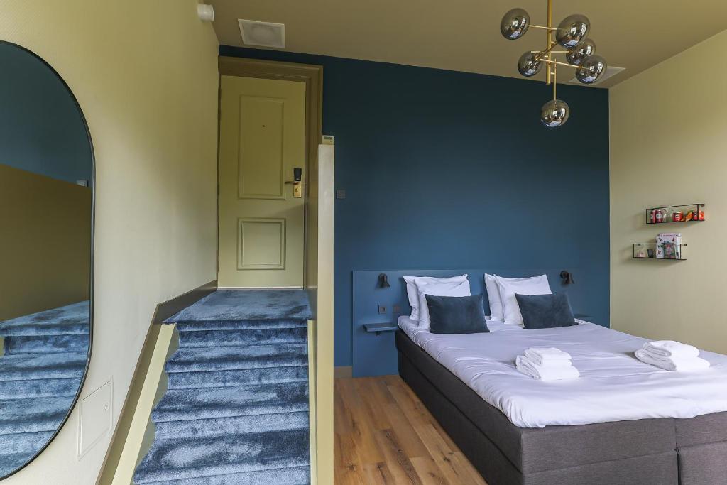 Postel nebo postele na pokoji v ubytování Hotel Corps de Garde