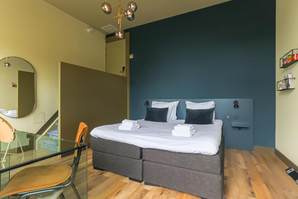 Postel nebo postele na pokoji v ubytování Hotel Corps de Garde