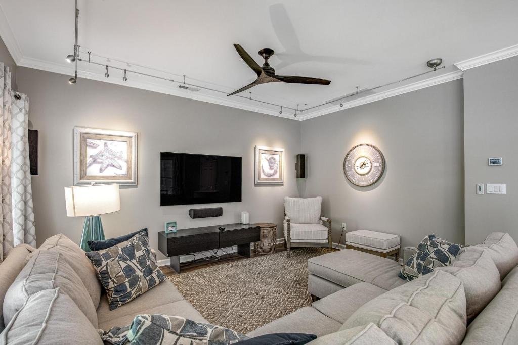 a living room with a couch and a flat screen tv at Oyster Bay Villas --- 37500 Kaitlyn Dr Unit #23 in Rehoboth Beach