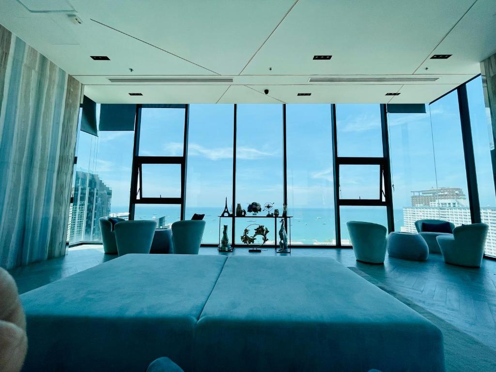 a room with a table and chairs in a building with windows at The base condo 142 by Pupu in Pattaya Central